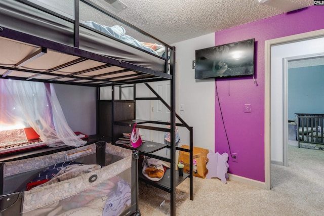 bedroom with baseboards, carpet, visible vents, and a textured ceiling