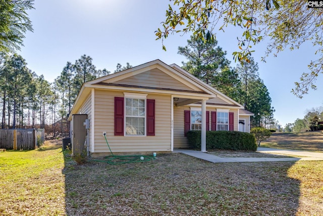 bungalow-style house with a front yard and fence