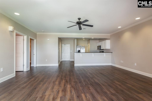 unfurnished living room with baseboards, dark wood-style flooring, a ceiling fan, and crown molding