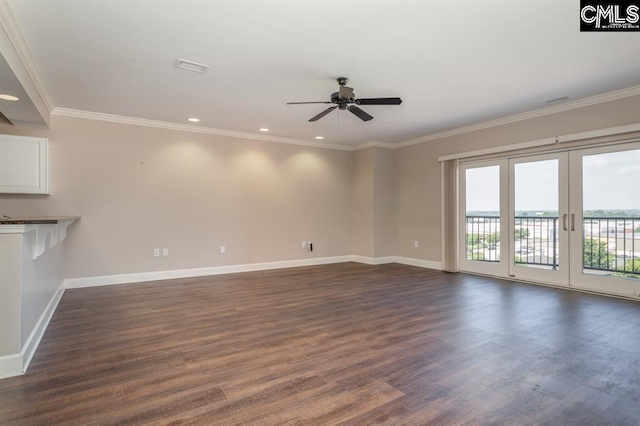 unfurnished living room featuring dark wood finished floors, crown molding, baseboards, and ceiling fan