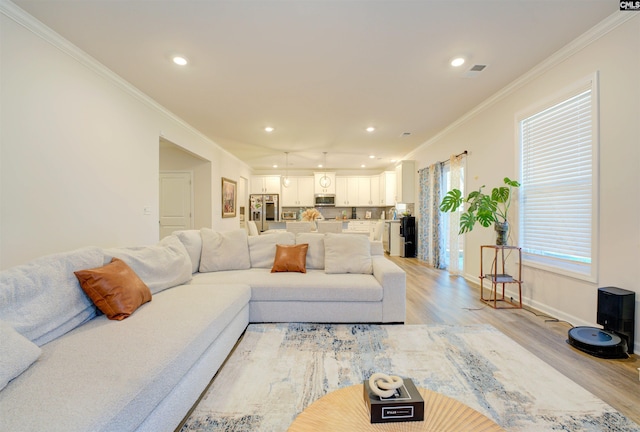 living area featuring light wood-style flooring, recessed lighting, and ornamental molding