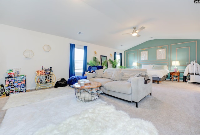 carpeted living room featuring visible vents, lofted ceiling, and a ceiling fan