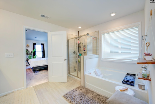 ensuite bathroom with visible vents, a stall shower, ensuite bath, recessed lighting, and a bath