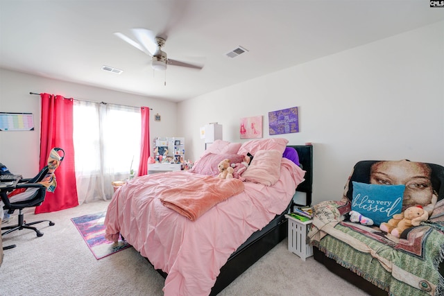 carpeted bedroom with a ceiling fan and visible vents