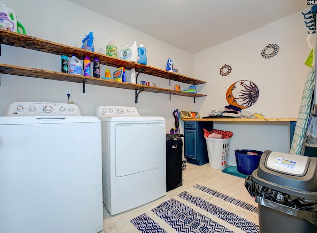 washroom with laundry area, independent washer and dryer, and light wood finished floors