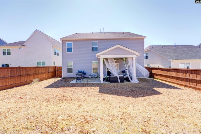 back of property with a patio and a fenced backyard