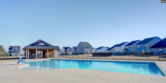 pool featuring fence and a residential view