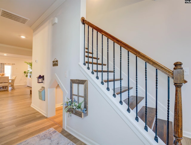 stairs with recessed lighting, visible vents, baseboards, and wood finished floors