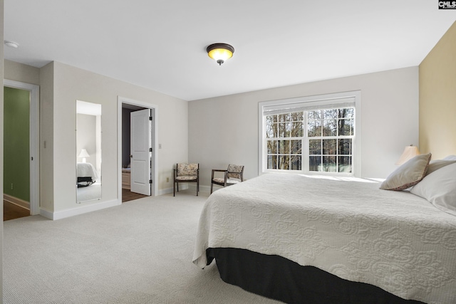 carpeted bedroom featuring baseboards