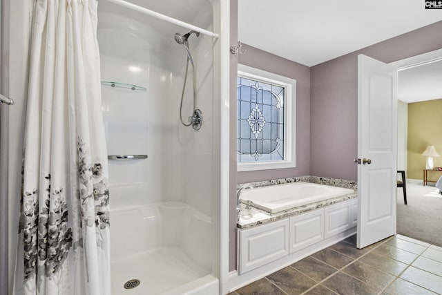 bathroom featuring a garden tub and a stall shower