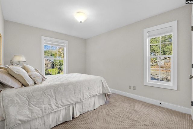 carpeted bedroom featuring baseboards