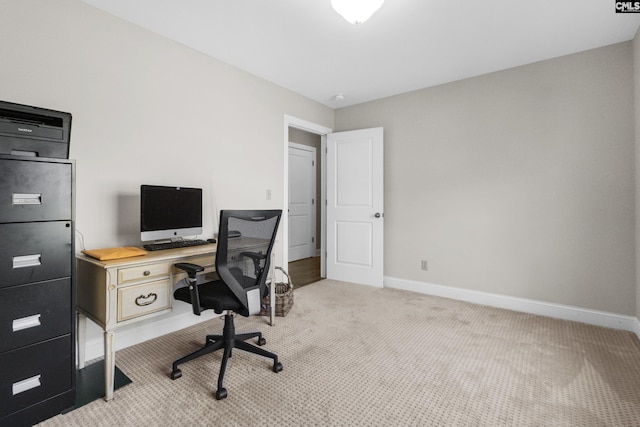 carpeted office space featuring baseboards