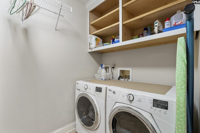 laundry area with washer and dryer, laundry area, and baseboards