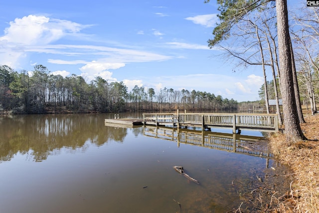 dock area with a view of trees and a water view