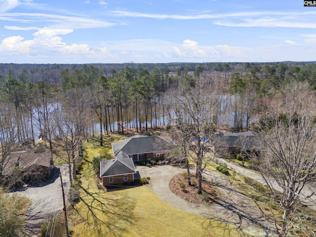 birds eye view of property featuring a view of trees