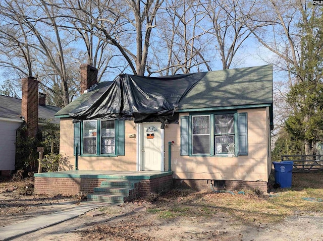 view of front of house with crawl space and fence