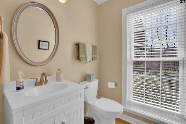 half bathroom featuring vanity and toilet