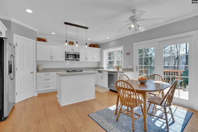 dining room featuring recessed lighting, light wood-type flooring, ornamental molding, and a ceiling fan