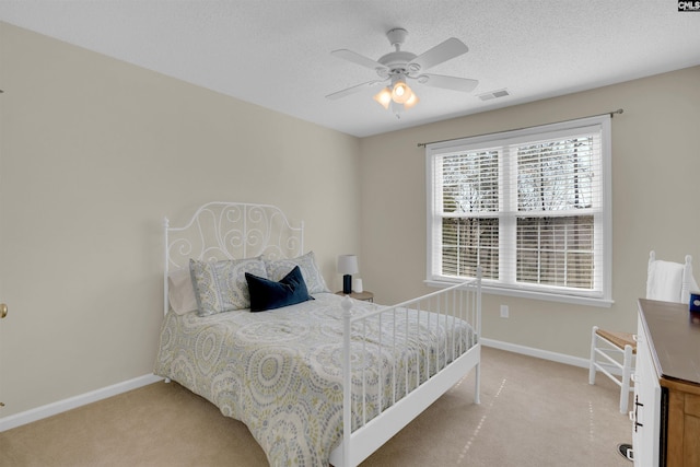 bedroom with visible vents, baseboards, and light colored carpet