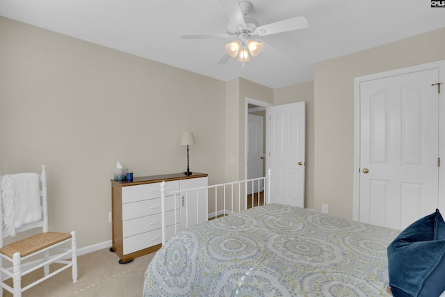 bedroom featuring light carpet, ceiling fan, and baseboards