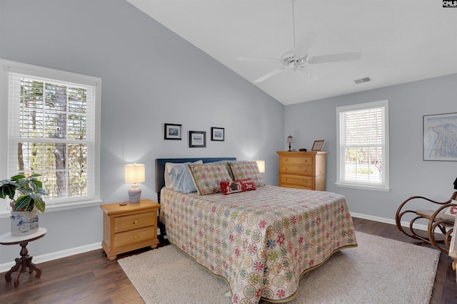 bedroom with dark wood finished floors, vaulted ceiling, baseboards, and ceiling fan