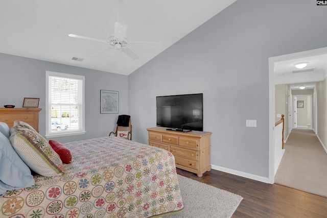 bedroom featuring dark wood-style floors, visible vents, baseboards, ceiling fan, and vaulted ceiling