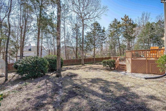 view of yard featuring fence and a wooden deck