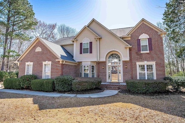 traditional home featuring brick siding