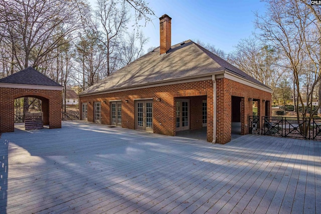 wooden deck with a gazebo and french doors