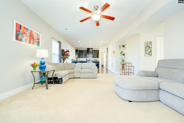 living room with recessed lighting, baseboards, light colored carpet, and a ceiling fan