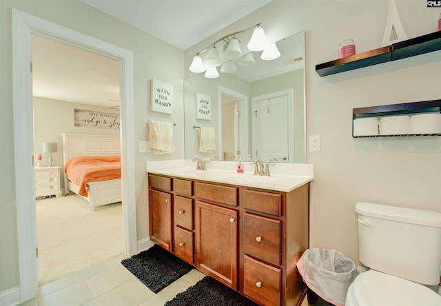 ensuite bathroom featuring double vanity, toilet, ensuite bathroom, and a sink