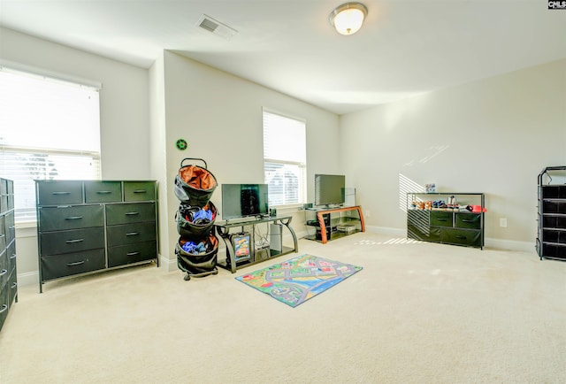 rec room featuring visible vents, baseboards, and carpet floors