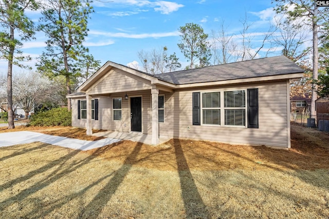 view of front of property with a front yard and fence