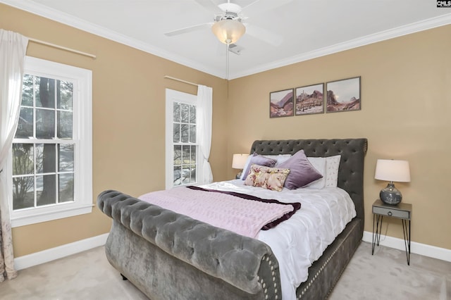 carpeted bedroom featuring a ceiling fan, baseboards, and ornamental molding