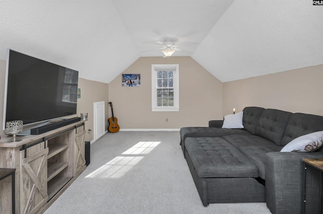 carpeted living room with baseboards, ceiling fan, and vaulted ceiling