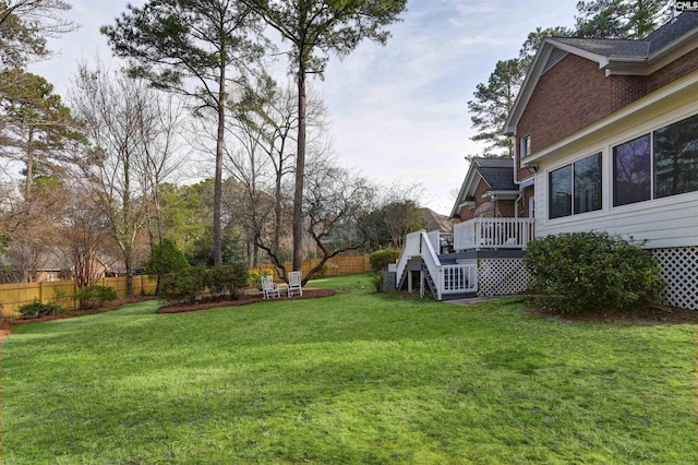 view of yard featuring fence and a wooden deck