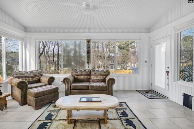 sunroom / solarium with a healthy amount of sunlight, ceiling fan, and vaulted ceiling