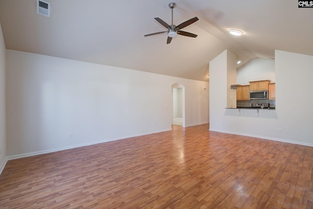 unfurnished living room featuring visible vents, a ceiling fan, arched walkways, light wood-style floors, and baseboards