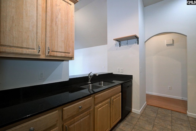 kitchen with baseboards, open shelves, arched walkways, a sink, and dishwasher