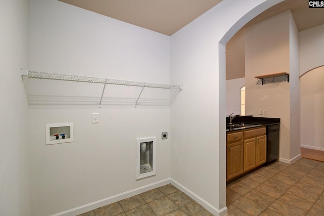 laundry room featuring electric dryer hookup, washer hookup, a sink, baseboards, and laundry area