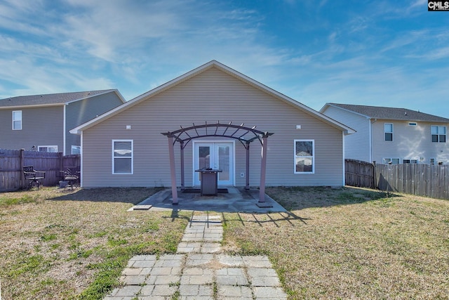 view of front of home with a fenced backyard, a pergola, a patio, and a front yard