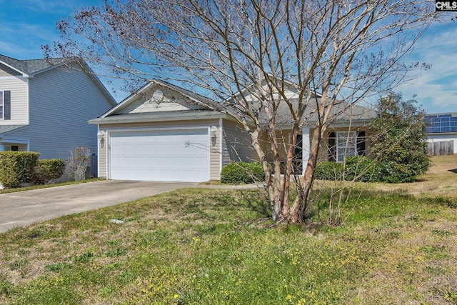 view of front of home featuring an attached garage, concrete driveway, and a front lawn