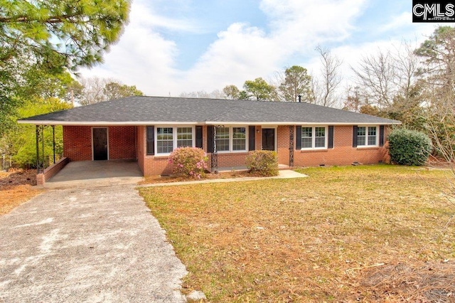 ranch-style house featuring brick siding, an attached carport, driveway, and a front yard