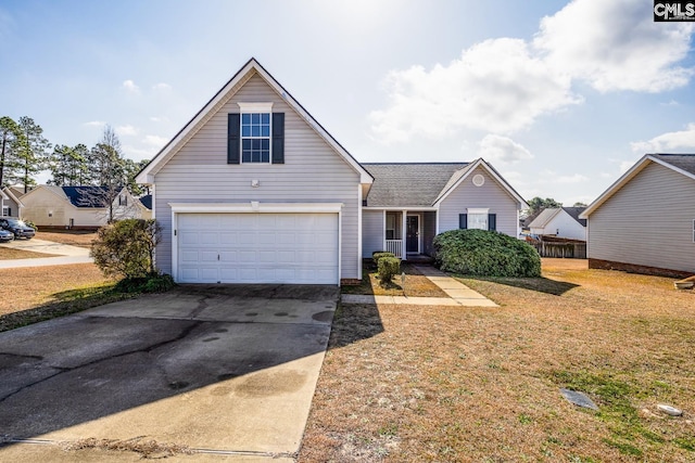 traditional-style house featuring a front yard, an attached garage, and driveway