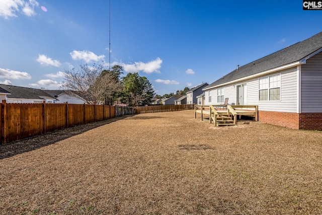 view of yard with a deck and a fenced backyard