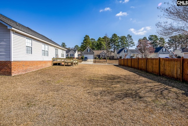 view of yard featuring a residential view and fence