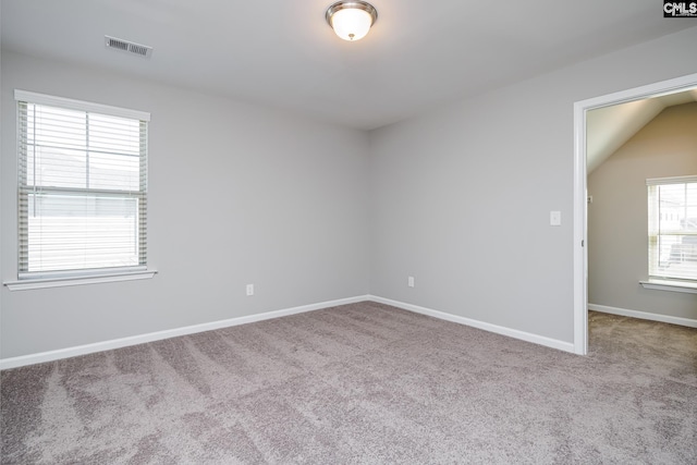 unfurnished room with baseboards, visible vents, and carpet floors