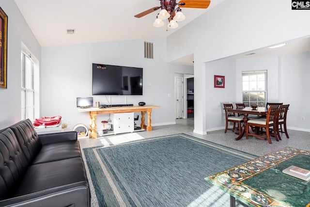 living room featuring visible vents, baseboards, and a ceiling fan