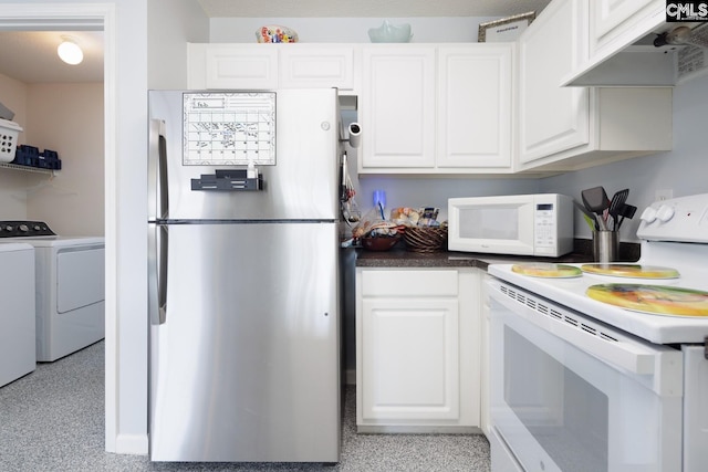 kitchen with under cabinet range hood, white appliances, white cabinetry, and washing machine and clothes dryer