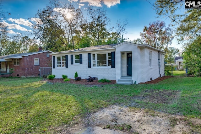 view of front of house featuring a gate, fence, a front lawn, crawl space, and brick siding